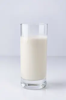 Vegetable milk in a glass on a white background