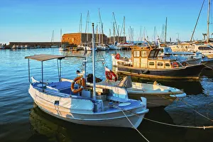 Venetian Fort Venetian fortress of Koules Castello in Heraklion and moored Greek fishing boats in port