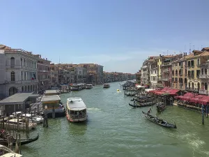 Venice canal with boats and gondoliers