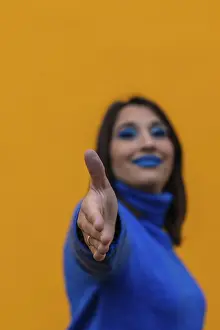 Vertical portrait of Young smiling businesswoman with blue makeup