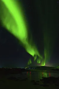 Vibrant green northern lights illuminating a tranquil night