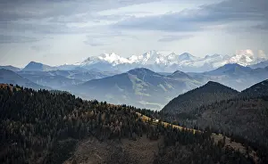 View of the Alpine foothills and main Alpine ridge with snow-covered peaks