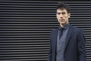 Front view of an attractive executive man wearing a suit while looking at camera