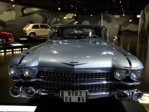 Front view of a blue vintage car with distinctive headlights