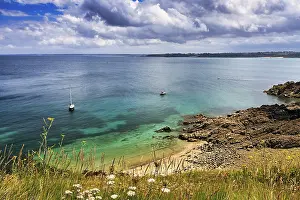 View from above of boats in small bay and rocky coast
