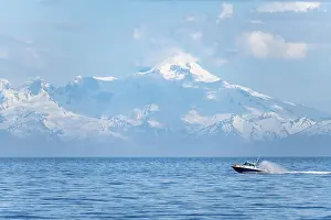 View over Cook Inlet to white mountain peaks of Mount Iliamna