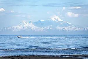 View over Cook Inlet to white mountain peaks of Mount Iliamna