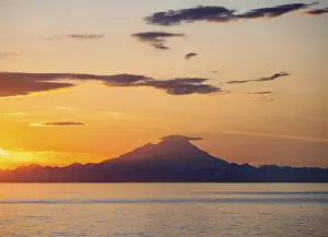 View of Cook Inlet on white mountain peaks of Mount Redoubt at sunset