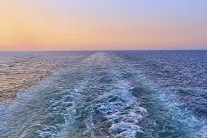 View from the cruise ship at sunset at the stern of the ship onto the stern waves