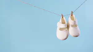Front view cute little baby shoes with copy space