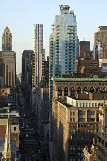 View from above onto the dark street canyon of Fifth Avenue with its skyscrapers