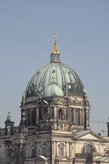 View of the dome of the Berlin Cathedral against a blue sky