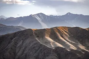 View over eroded mountainous landscape with brown hills