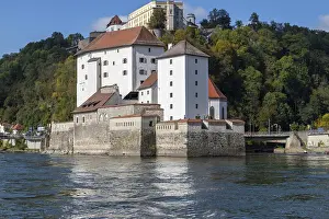 View at fortress Veste Oberhaus in Passau during a ship excursion in autumn with colorfull trees