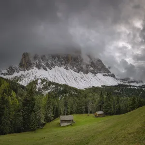 View of a part of the Geisler group in the foreground two mountain huts