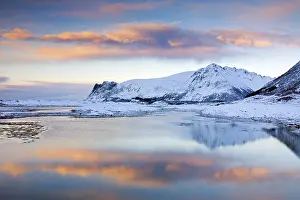 View over Gimsoystraumen Fjord and mountains in the snow in winter