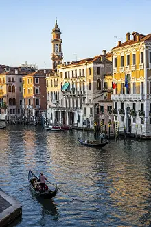 View of the Grand Canal with gondoliers at sunset
