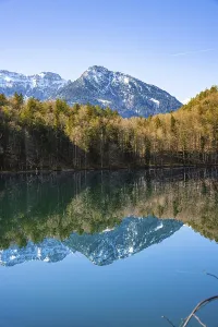 View over the green lake with mountain in the background