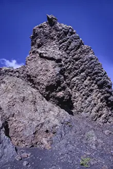 Framed Print : View of a high volcanic rock structure under a clear blue sky Framed Print : View of a high volcanic rock structure under a clear blue sky