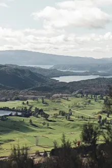View of hilly landscape and a lake from Rainbow Mountain in Rotorua