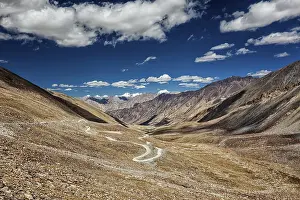 View of Karakoram range and road in valley from Kardung La