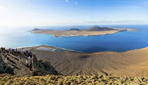 View of La Graciosa island with volcanic craters in the evening light