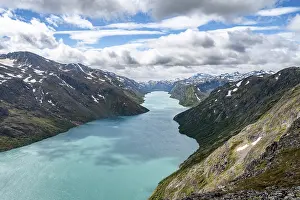 View of Lake Gjende and snowy mountains