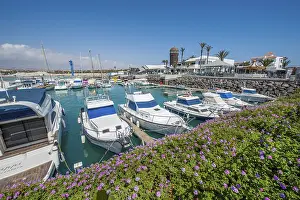 View of marina sport boat harbour in east atlantic bay Caleta de Fuste in front of holiday resort Castillo on east