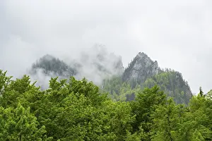 View into the mountains next to Lake Offensee on a rainy day in spring