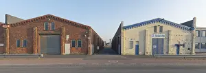 Category Historic EN Prints: View of old brick-built Langerhallen with a driveway in between in the evening light