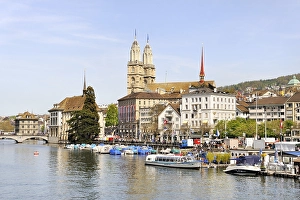 View from Quaibruecke bridge across the Limmat River towards Limmatquai quay and Grossmuenster church
