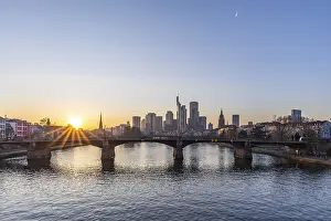 View over the river Main with a modern skyline in the background in the evening