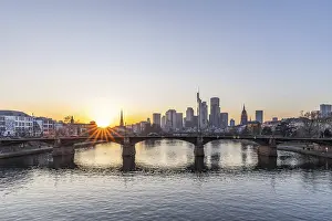 View over the river Main with a modern skyline in the background in the evening
