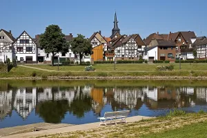 View over the river Weser to the old town centre of Bodenwerder with the church tower of St