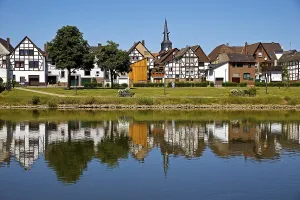 View over the river Weser to the old town centre of Bodenwerder with the church tower of St