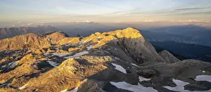 View of rocky plateau with remnants of snow in the evening light