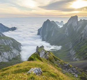 View over Saentis mountains into the valley of Meglisalp at sunrise