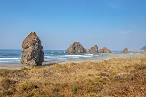 View over sandy beach and large monolithic rocks