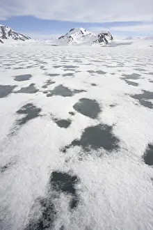 View of sea ice and snow-covered coastal mountains