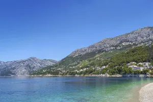 View of the shore of the Adriatic Sea with mountains in the background in the district of Brela
