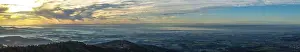 The view shows the vast landscape with a gentle fog at sunrise