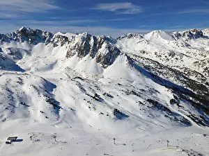 View of ski slopes in an alpine resort with snow-covered slopes