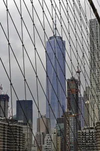 View of skyscrapers through the cables of the Brooklyn Bridge in New York