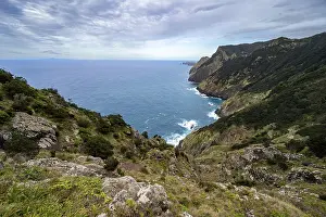 View of steep cliffs and mountains overgrown with forest