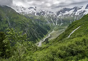 View of Stilluppbach and cloudy mountain peaks in Stillupptal