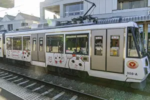 Side view of a tram with cat motifs