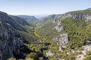 View into a valley with rock walls in the mountains