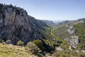 View into a valley with rock walls in the mountains