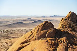 View of the vast, dry landscape of Spitzkoppe from the top of a rock