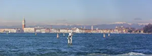 View of Venice from Lido, snow-capped alpine peaks in the back